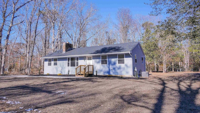 single story home with a chimney and central AC