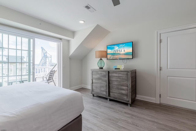 bedroom featuring a ceiling fan, light wood-type flooring, visible vents, and baseboards