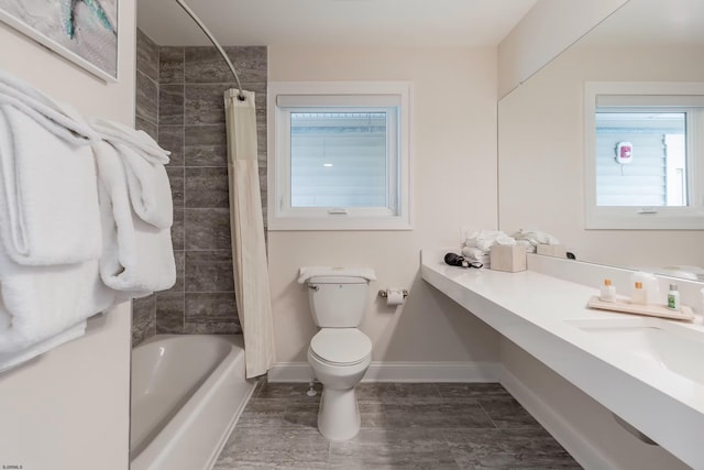 bathroom with shower / tub combo, baseboards, vanity, and toilet