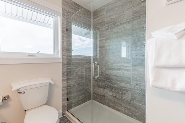 bathroom featuring a shower stall and toilet