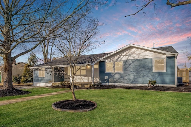 ranch-style house with entry steps and a yard