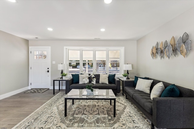 living room with baseboards, wood finished floors, and recessed lighting