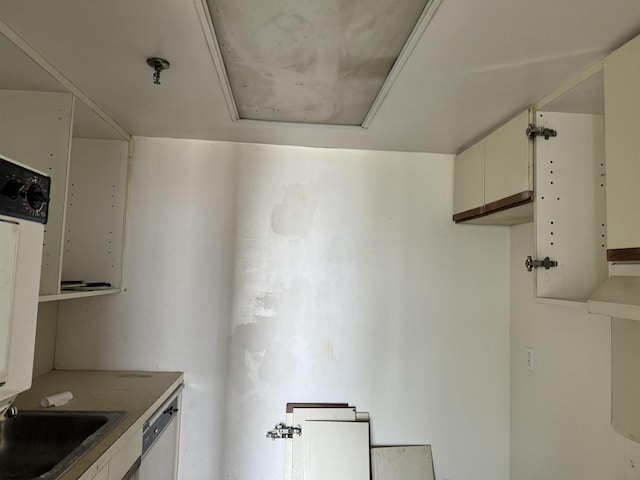 kitchen with white cabinetry, light countertops, and dishwasher