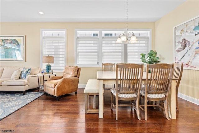 dining room featuring a chandelier, dark wood-type flooring, recessed lighting, and baseboards