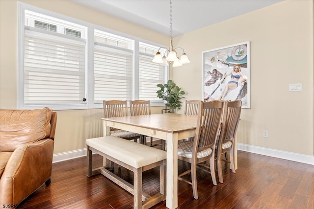 dining space featuring a notable chandelier, baseboards, and dark wood-style flooring