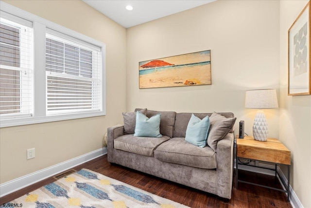 living room with recessed lighting, dark wood-style flooring, visible vents, and baseboards