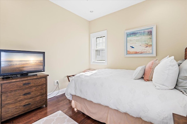 bedroom featuring dark wood finished floors and baseboards