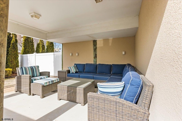 view of patio with an outdoor hangout area and fence