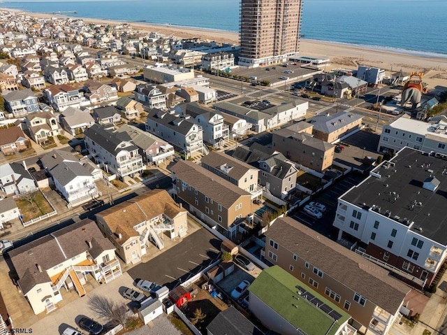 bird's eye view featuring a water view and a beach view