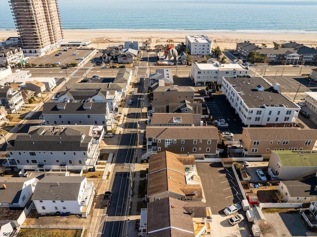 birds eye view of property with a view of the beach and a water view