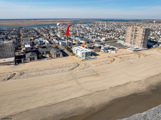 birds eye view of property with a view of city and a water view