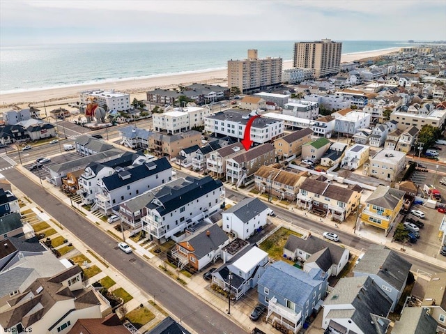 aerial view with a water view and a view of the beach