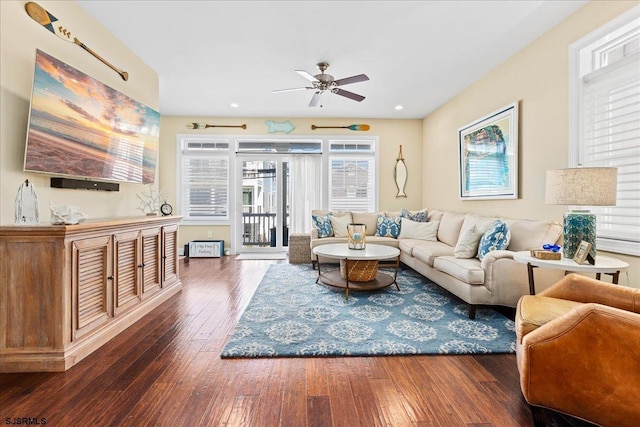 living area featuring ceiling fan and dark wood finished floors