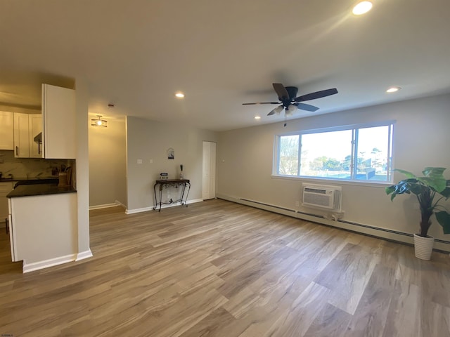 living room featuring light wood-style flooring, recessed lighting, a ceiling fan, baseboards, and baseboard heating