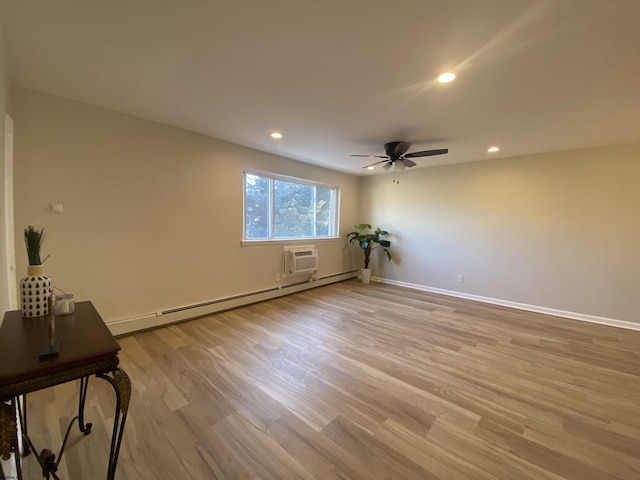 spare room with light wood finished floors, a baseboard radiator, recessed lighting, a wall mounted air conditioner, and baseboards