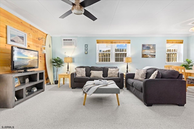 living area featuring carpet, a wall unit AC, crown molding, ceiling fan, and wooden walls