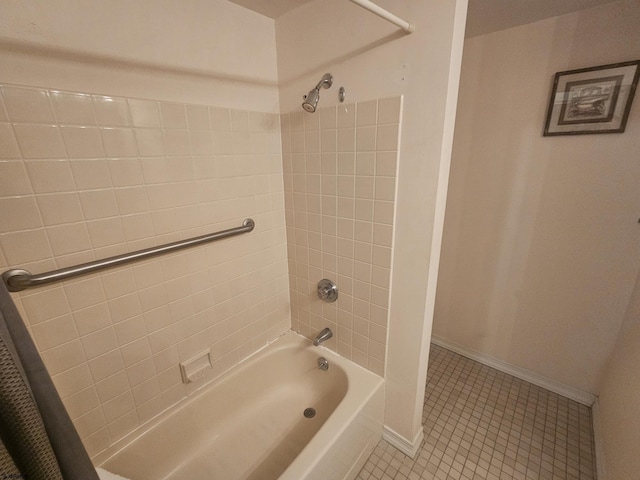 bathroom with tile patterned flooring, tub / shower combination, and baseboards