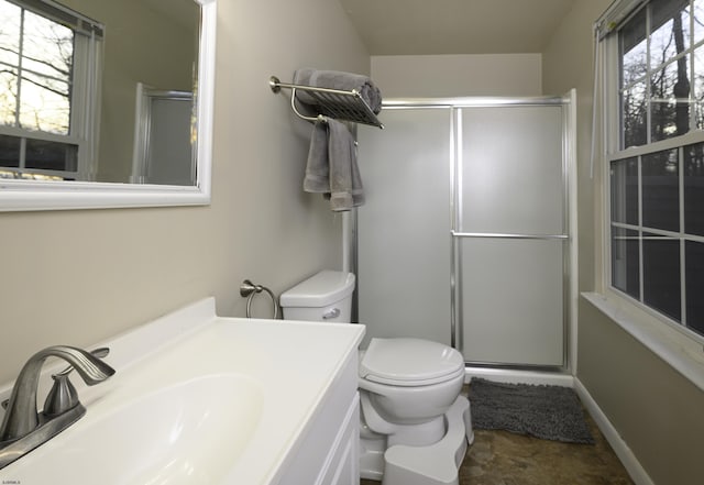 bathroom featuring toilet, a shower stall, a wealth of natural light, and vanity