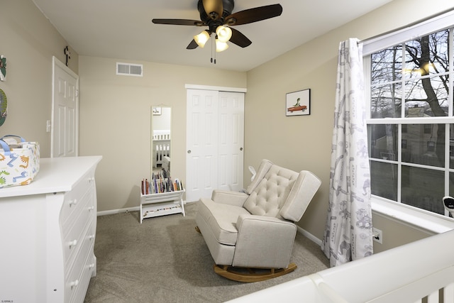 living area with carpet floors, baseboards, visible vents, and ceiling fan