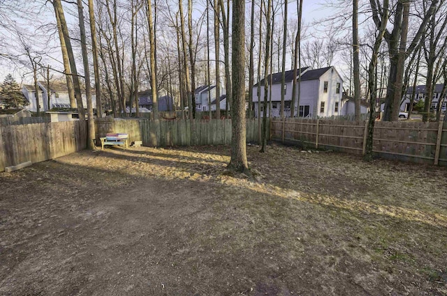 view of yard with a residential view and fence