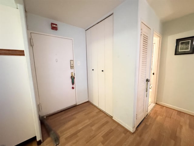 interior space featuring light wood finished floors and baseboards