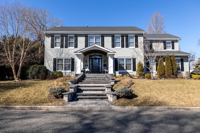 colonial-style house with a front yard