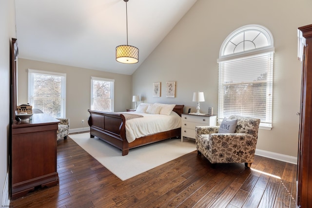 bedroom featuring dark wood-style floors, high vaulted ceiling, and baseboards