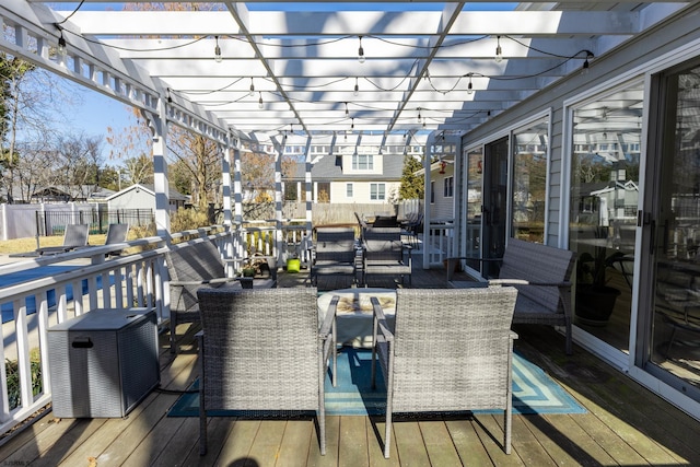 deck with a residential view, fence, a pergola, and outdoor dining space