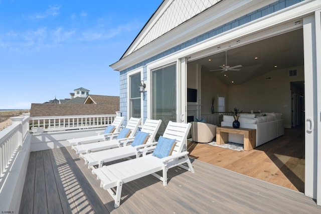 wooden deck with ceiling fan and visible vents