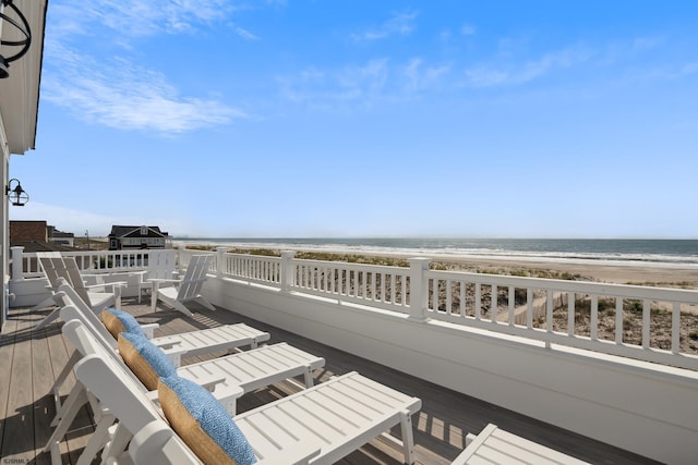 wooden terrace with a water view and a beach view