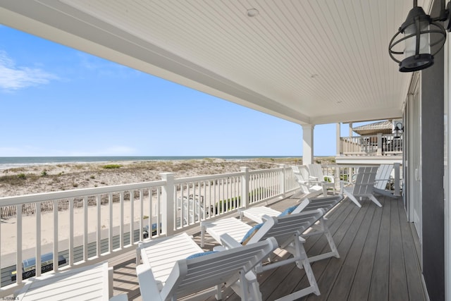 deck with a water view and a view of the beach