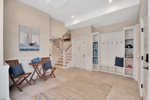 sitting room with tile patterned floors, stairway, and recessed lighting