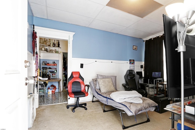 bedroom with wainscoting, carpet flooring, and a paneled ceiling