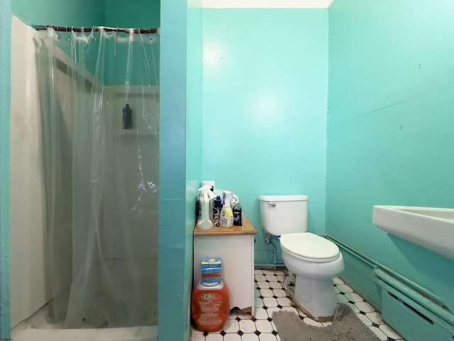 full bath featuring a stall shower, toilet, and tile patterned floors