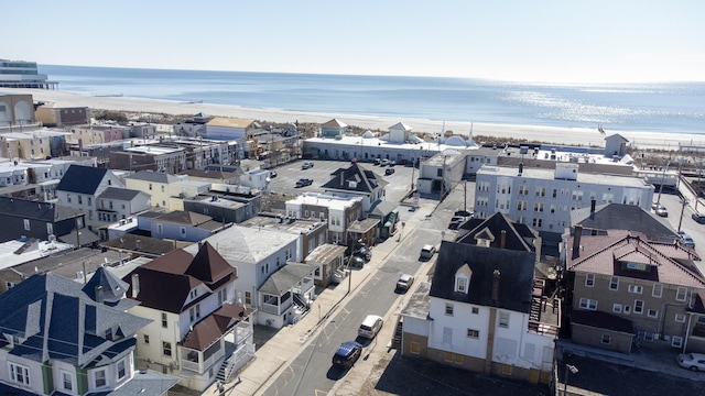 bird's eye view with a water view and a view of the beach