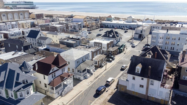 drone / aerial view featuring a view of the beach and a water view