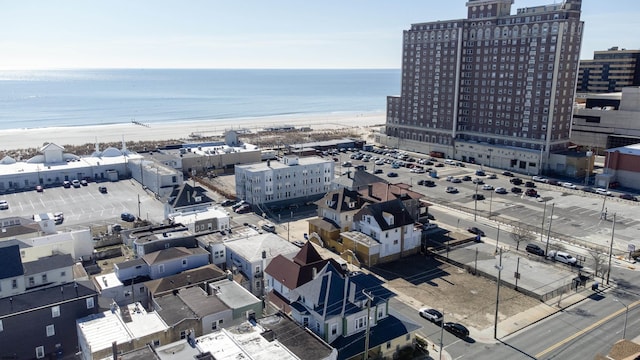 birds eye view of property with a view of the beach, a water view, and a city view