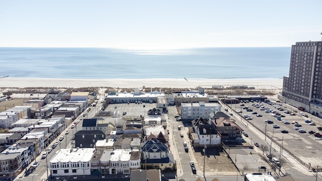 birds eye view of property featuring a water view and a view of the beach