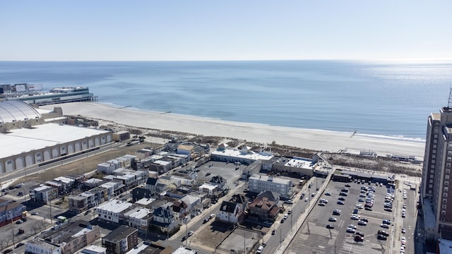 birds eye view of property with a water view and a beach view