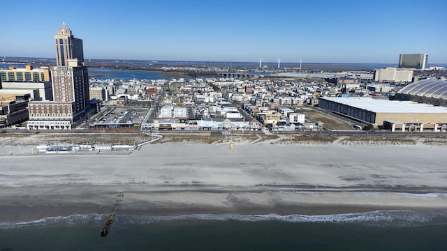 drone / aerial view featuring a view of city and a water view