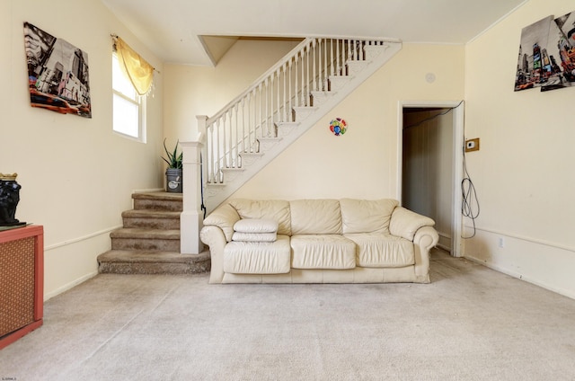 carpeted living room featuring stairway