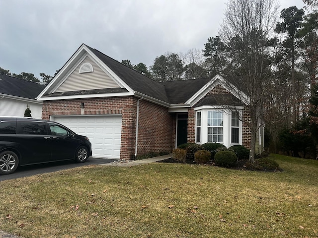 ranch-style house with driveway, brick siding, a front lawn, and an attached garage