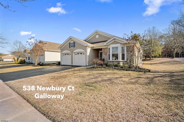 view of front of house featuring driveway, stone siding, a garage, and a front lawn