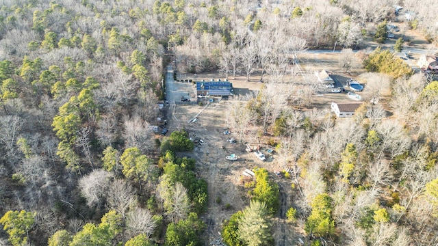 bird's eye view with a wooded view