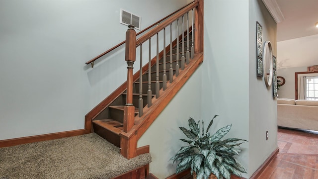 stairs with visible vents and baseboards