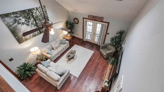 living area with lofted ceiling, a ceiling fan, wood finished floors, and french doors