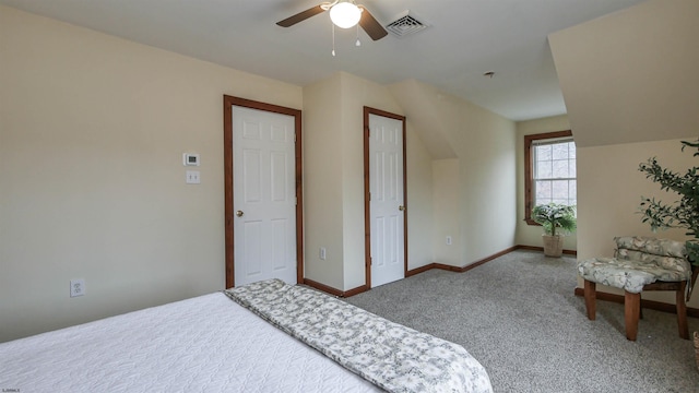 carpeted bedroom featuring a ceiling fan, visible vents, and baseboards