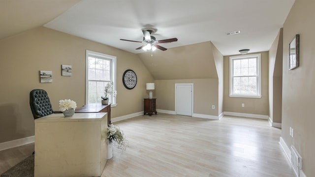 bonus room with light wood-type flooring, a healthy amount of sunlight, visible vents, and lofted ceiling