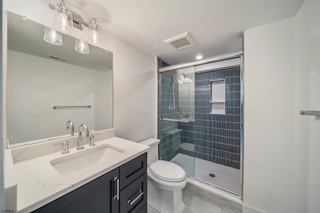 bathroom with visible vents, a shower stall, toilet, and vanity