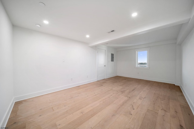 unfurnished room with visible vents, light wood-style flooring, and baseboards